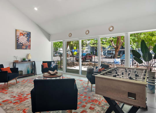 Community Clubhouse with Lounge Furniture and Game Tables at Overlook Apartments located in Salt Lake City, UT.