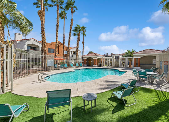 Community Swimming Pool with Pool Furniture at Stonegate Apartments located in Las Vegas, NV.