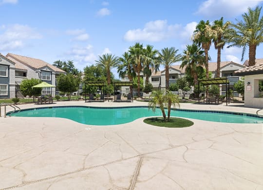 Community Swimming Pool with Pool Furniture at Monterra Apartments located in Las Vegas, NV.