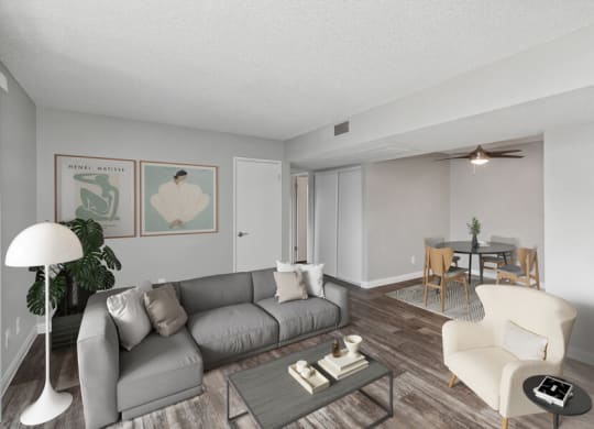 3 Bedroom Apartments in West Las Vegas, NV - Accent on Rainbow - Open Living And Dining Area With Gray Sectional Sofa, Coffee Table, Ceiling Fan, And Vinyl Plank Flooring