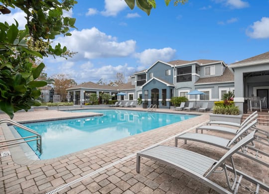 Community Swimming Pool with Pool Furniture at Westland Park Apartments in Jacksonville, FL.