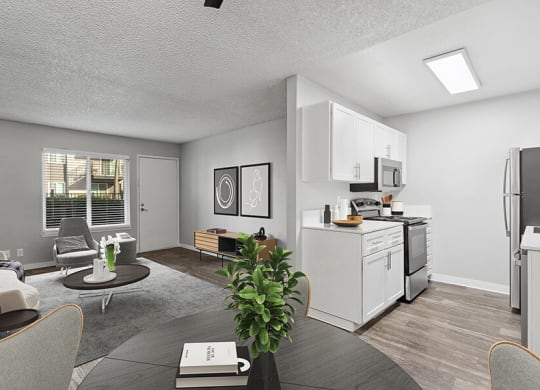 Model Dining Room and Kitchen Area with View of Living Room at The Archer Apartments in Sacramento, CA.
