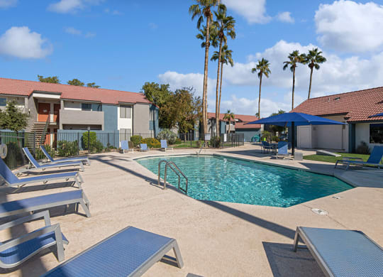 Community Swimming Pool with Pool Furniture at Peaks on 4th Apartments in Avondale, AZ.