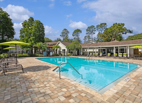 Sparkling swimming pool and pool deck at Retreat at Crosstown Apartments