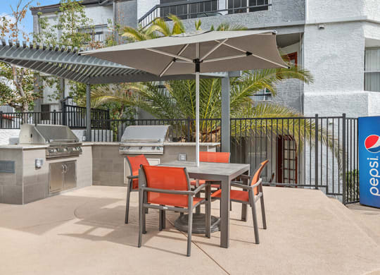 Outdoor BBQ Area with Furniture and Canopy at Crystal Creek Apartments in Phoenix, AZ.