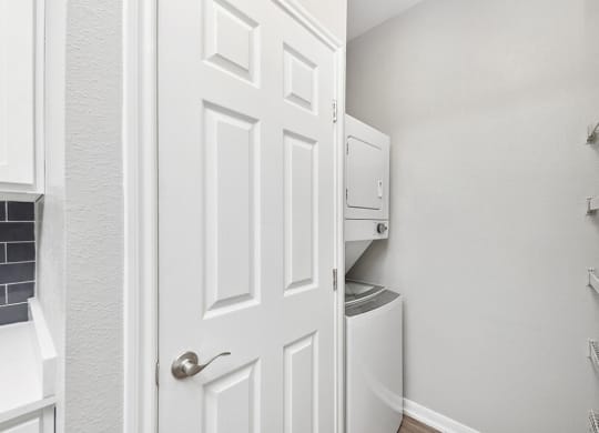 Model Laundry Room with Washer & Dryer at Hidden Creek Apartments located in Lewisville, TX.