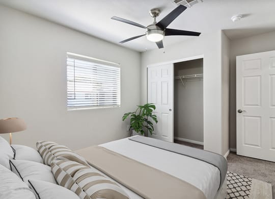 Model Bedroom with Carpet, Closet & Window View at Loma Vista Apartments in Las Vegas, NV.