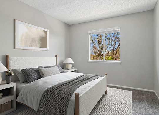 Model Bedroom with Carpet and Window View at Fullerton Hills Apartments located in Fullerton, CA.