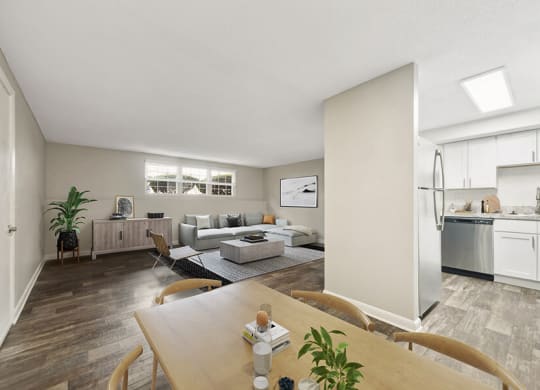 Model Dining Room with Wood-Style Flooring and View of Kitchen at Meadows at Marlborough Apartments located in Marlborough, MA.
