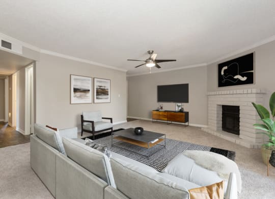 Model apartment living room with a couch and a tv at Saratoga Ridge, Arizona