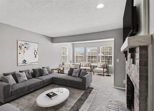 Model Living Room with Carpet and Fireplace at Abbington Heights Apartments in Antioch, TN.