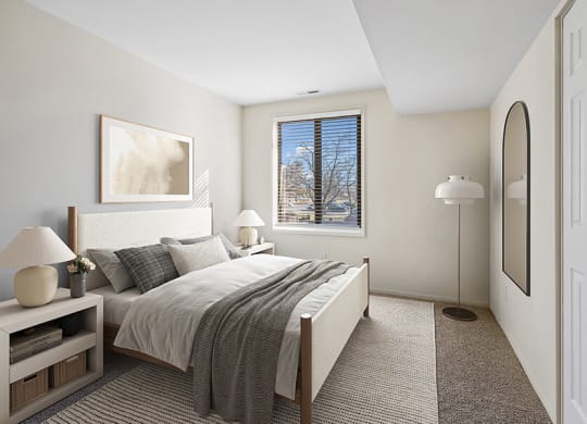 Model Bedroom with Carpet and Window View at Spring Parc Apartments in Silver Spring, MD.