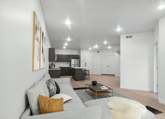 Model living room with view of kitchen