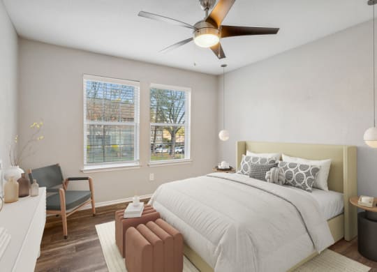 a bedroom with a large bed and a ceiling fan