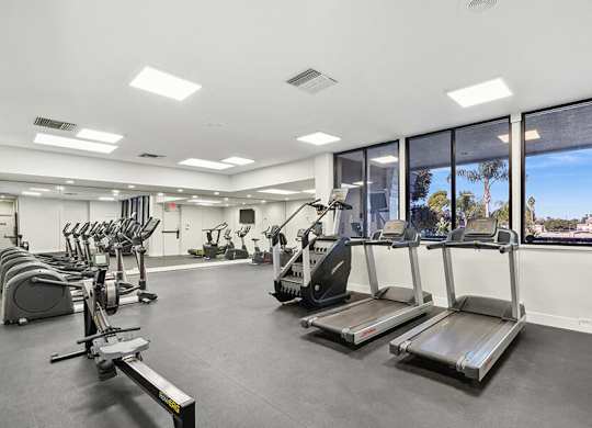 Community Fitness Center with Equipment at Madison Park Apartments located in Anaheim, CA.