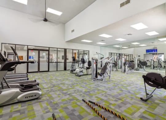 a gym with treadmills and other exercise equipment