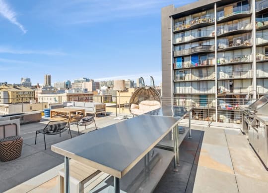 Outdoor kitchen space with BBQ grills at TL Residences