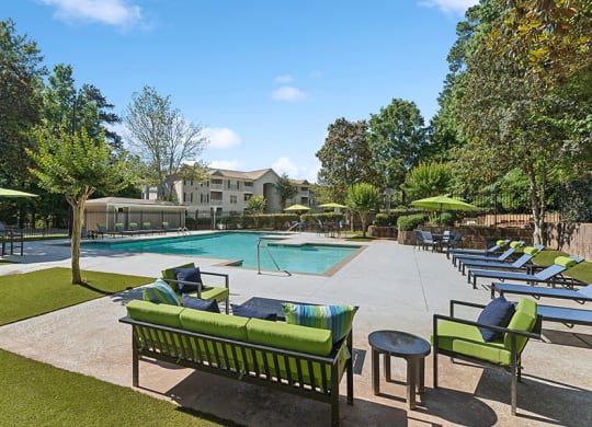 Community Swimming Pool with Pool Furniture at Retreat at Stonecrest Apartments located in Lithonia, GA.