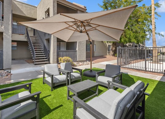 Outdoor Lounge Area with Covered Furniture at Saddle Ridge Apartments in Tucson, AZ.