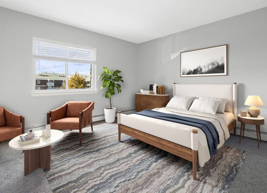 Model Bedroom with Carpet and Window View at Stone Ends Apartments in Stoughton, MA.