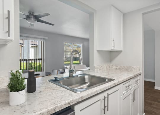 Model Kitchen with White Cabinets and Wood-Style Flooring at Overlook Point Apartments in Salt Lake City, UT.