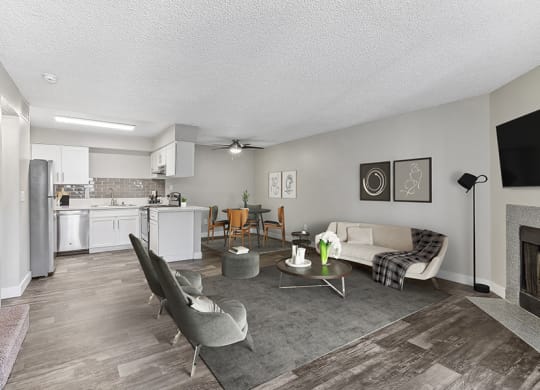 Model Living Room with Wood-Style Flooring and Fireplace at Meadow Ridge Apartments in Las Vegas, NV.