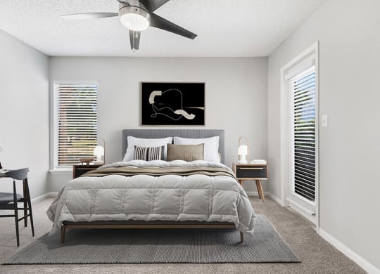 Model Bedroom with Carpet and Patio Accessibility at Rosehill Preserve Apartments located in Orlando, FL.