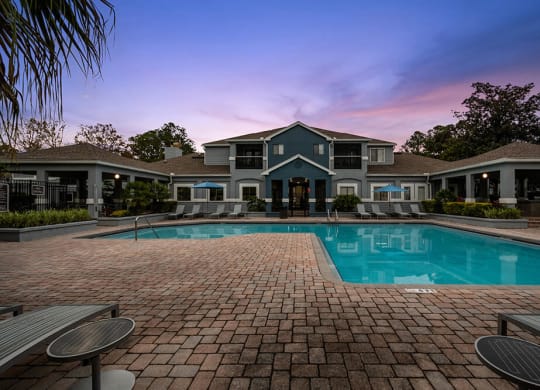Community Swimming Pool with Pool Furniture at Westland Park Apartments in Jacksonville, FL.