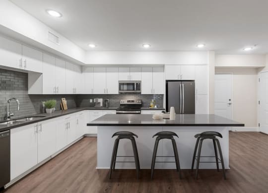 Model kitchen with white cabinetry