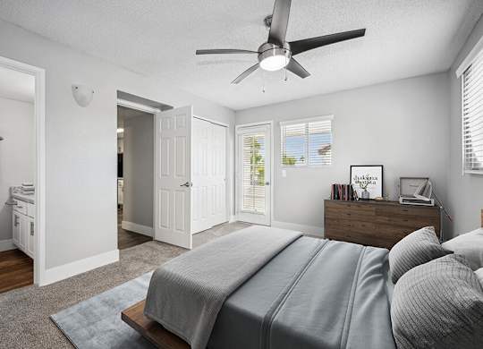 Model Bedroom with Carpet and attached Bathroom at Stillwater Apartments located in Glendale, AZ.