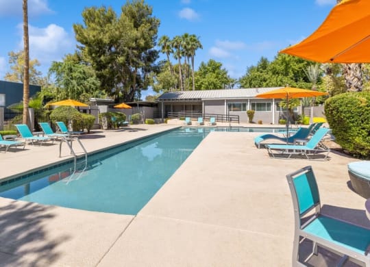 Community Swimming Pool with Pool Furniture at Lakeside Casitas Apartments in Tucson, AZ.