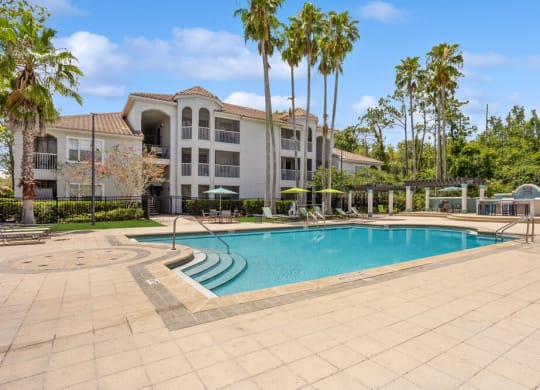 Swimming pool and pool deck with apartment building in background