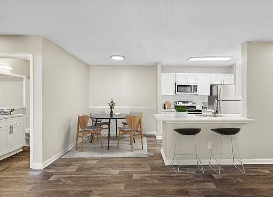Model Dining Room and Kitchen Area with Wood-Style Flooring at Element 41 Apartments located in Marietta, GA.
