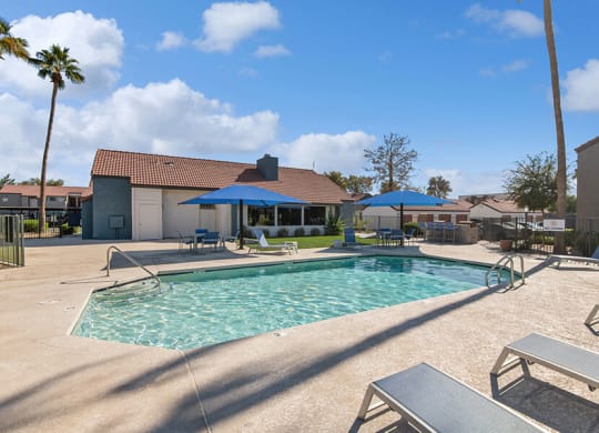 Community Swimming Pool with Pool Furniture at Peaks on 4th Apartments in Avondale, AZ.