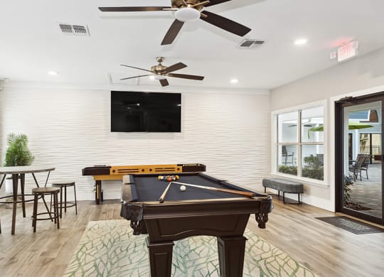 Community Clubhouse with Pool Table Area at Retreat at Crosstown Apartments in Riverview, FL.