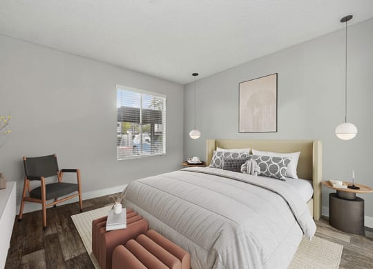 Model Bedroom with Wood-Style Flooring and Window View at Crystal Creek Apartments located in Phoenix, AZ.