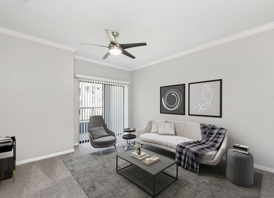 Model Living Room with Carpet and Patio Accessibility at Hidden Creek Apartments located in Lewisville, TX.