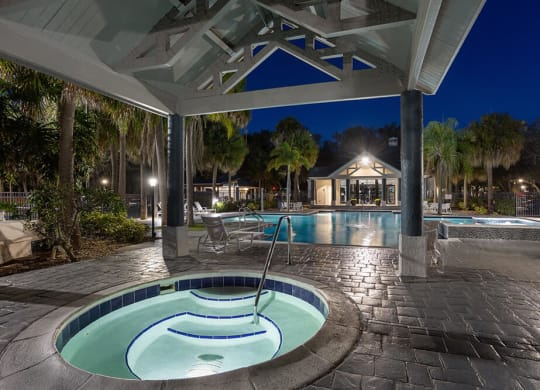 Community Swimming Pool with Pool Furniture at Caribbean Breeze Apartments in Tampa, FL.
