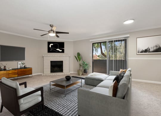 Model apartment living room with a couch and a chair and a ceiling fan at Saratoga Ridge, Phoenix, Arizona, 85022