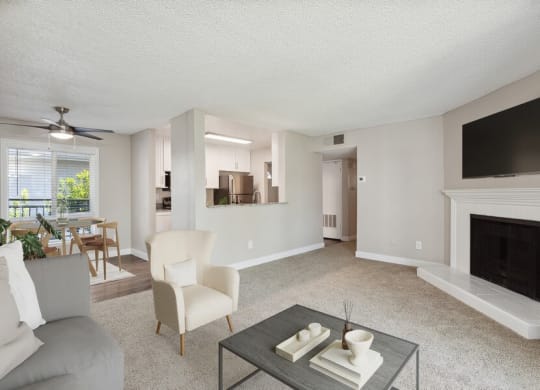 Model living room with a fireplace and a flat screen tv