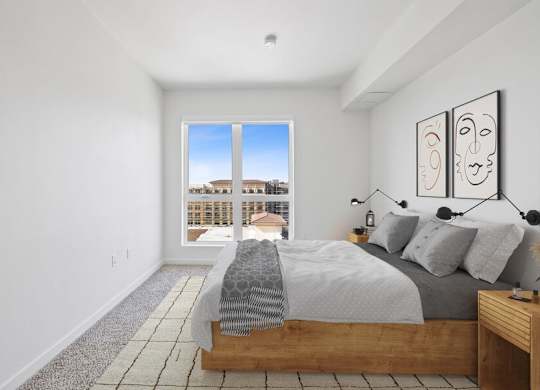 Model bedroom with carpeting and extra large window