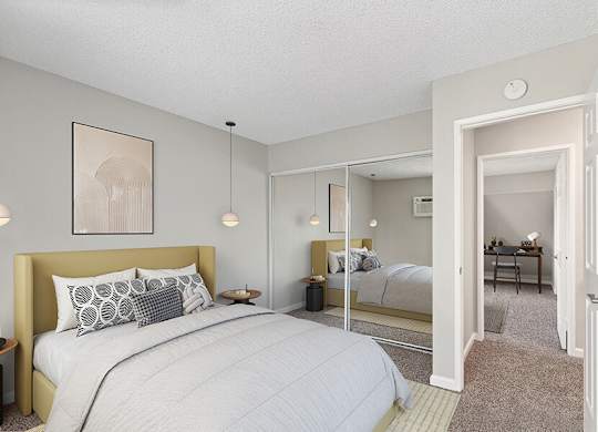 Model Bedroom with Carpet and Closet at Horizon Apartments located in Santa Ana, CA.