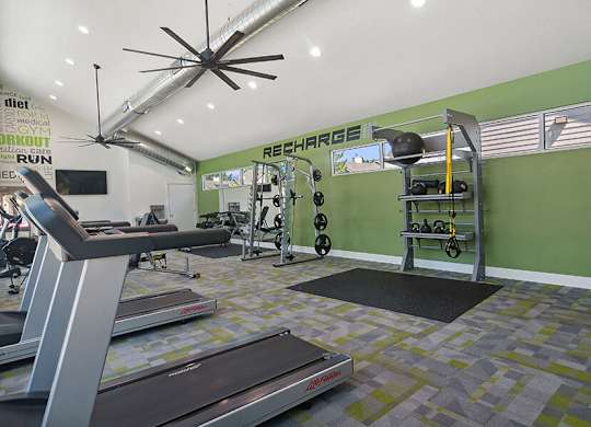 Community Fitness Center with Equipment at Broadmoor Village Apartments located in West Jordan, UT.