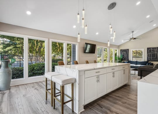 Community Clubhouse with Kitchenette and Lounge Furniture at Lakeside Retreat Apartments located in Peachtree Corners, GA.