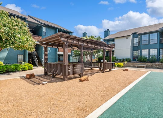 Outdoor Covered Seating Area at Bridges at Deer Run Apartments in Dallas, TX.
