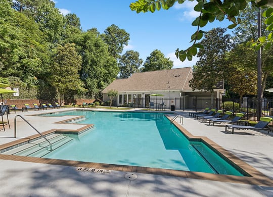 Community Swimming Pool with Pool Furniture at Retreat at Stonecrest Apartments located in Lithonia, GA.