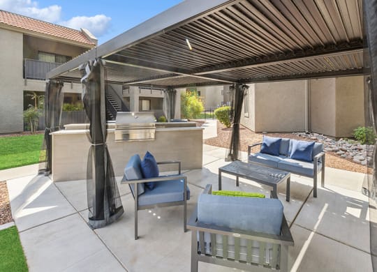 Outdoor BBQ Area with Furniture and Canopy at Saddle Ridge Apartments in Tucson, AZ.