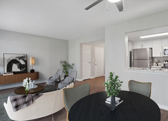 Model Living/Dining Room with Wood-Style Flooring and View of Kitchen at Overlook Point Apartments in Salt Lake City, UT.