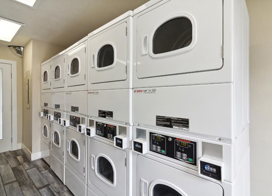 Community Laundry Center with Washing Machines and Dryers at Meadow Ridge Apartments in Las Vegas, NV.