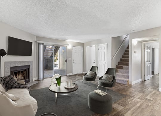 Model Living Room with Wood-Style Flooring and Patio Accessibility at Meadow Ridge Apartments in Las Vegas, NV.
